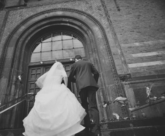 Wedding couple entering a historic building