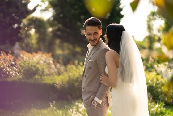 Newlyweds embracing in an outdoor garden